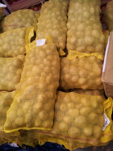 Potatoes in yellow mesh export bags